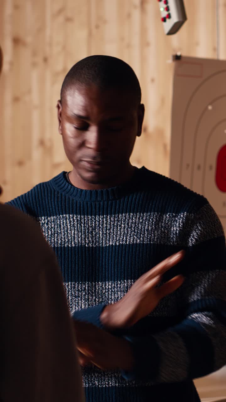 Vertical video Shooting range safety officer ensuring clients are following rules
