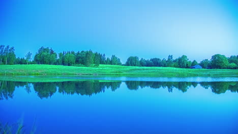a sunrise timelapse over a picturesque pond with a cottage
