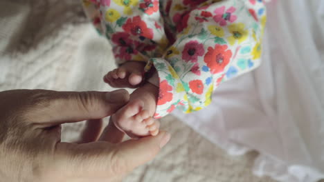 taking care of baby male hand touching little feet