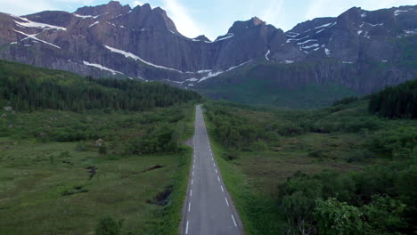 Aerial-shot-of-a-Camper-van-driving-on-the-scenic-road-to-Nusfjord-in-Lofoten-Island,-Norway