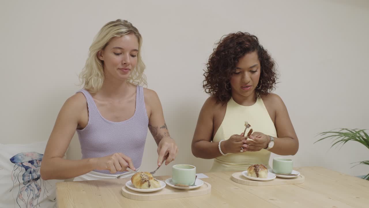Two women enjoying dessert at a table