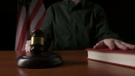 judge in courtroom with gavel and book