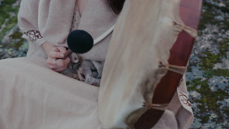 spiritual-woman-playing-a-shamanic-drum-medium-detail-shot