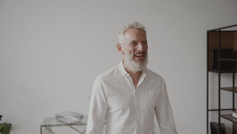 two happy senior men friends greeting each other with a hug and laughing at home 1