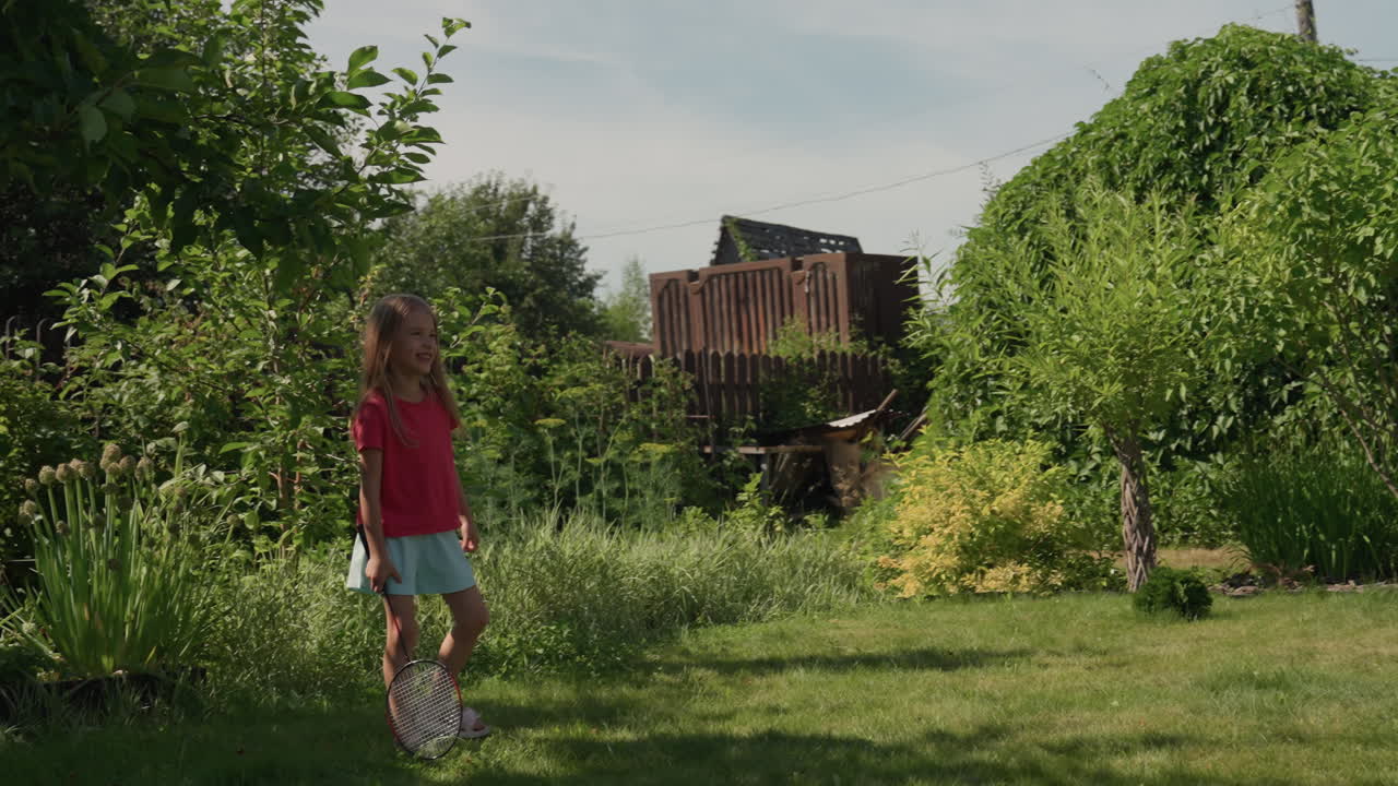 White Mother Teaching Daughter To Walk Dog Along Green Lawn, Pink Dressed Woman Holds Leash While Child Follows, Corgi Visible At Edge, Serene Suburban Garden Lesson About Pet Care And Family