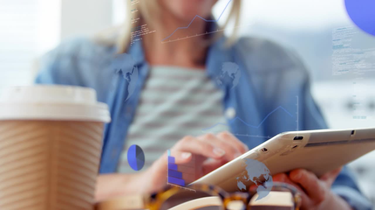 Mid-adult woman tapping tablet at table, generating animated charts and analyzing data for business