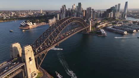 beautiful aerial reveal sydney harbour bridge, opera house and downtown with skyscrapers.