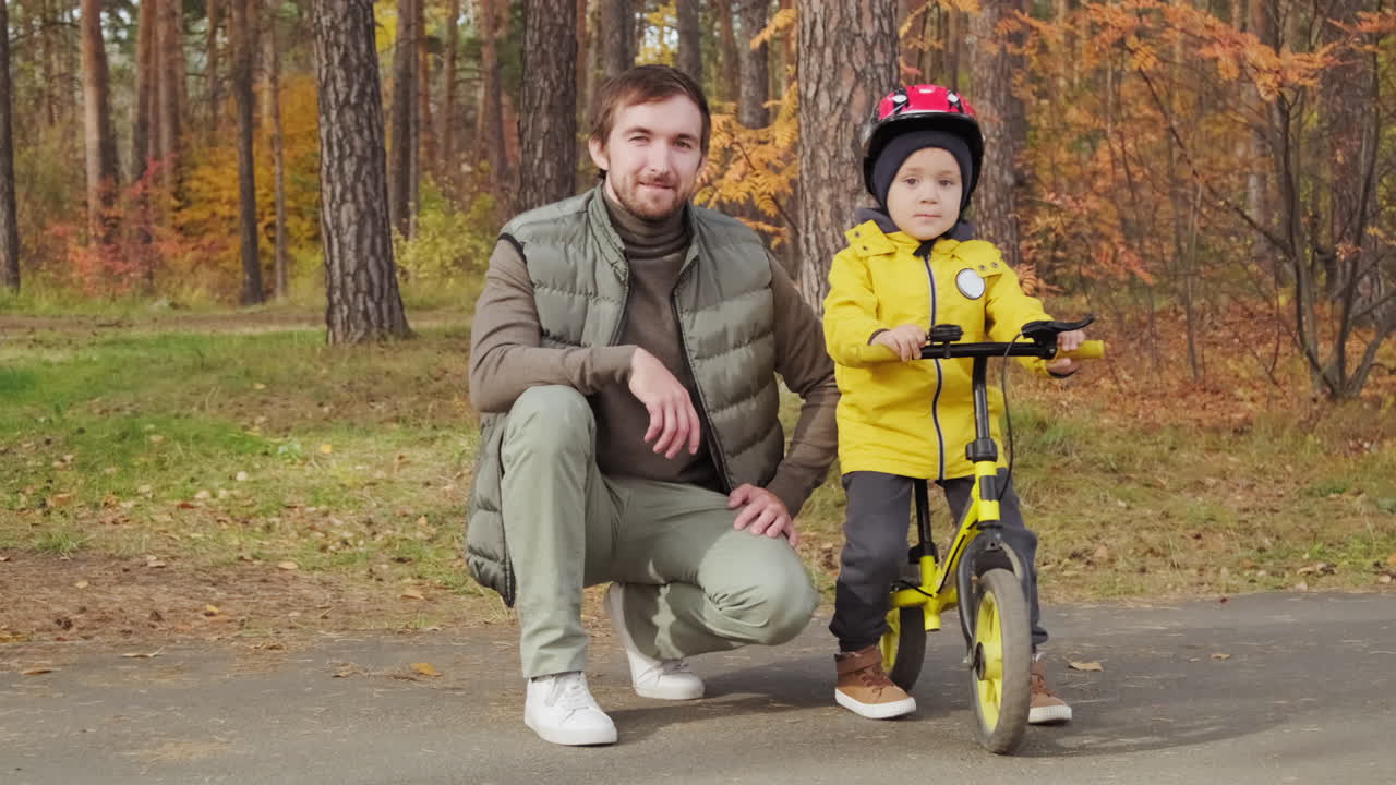 Father and child riding a bike in the park