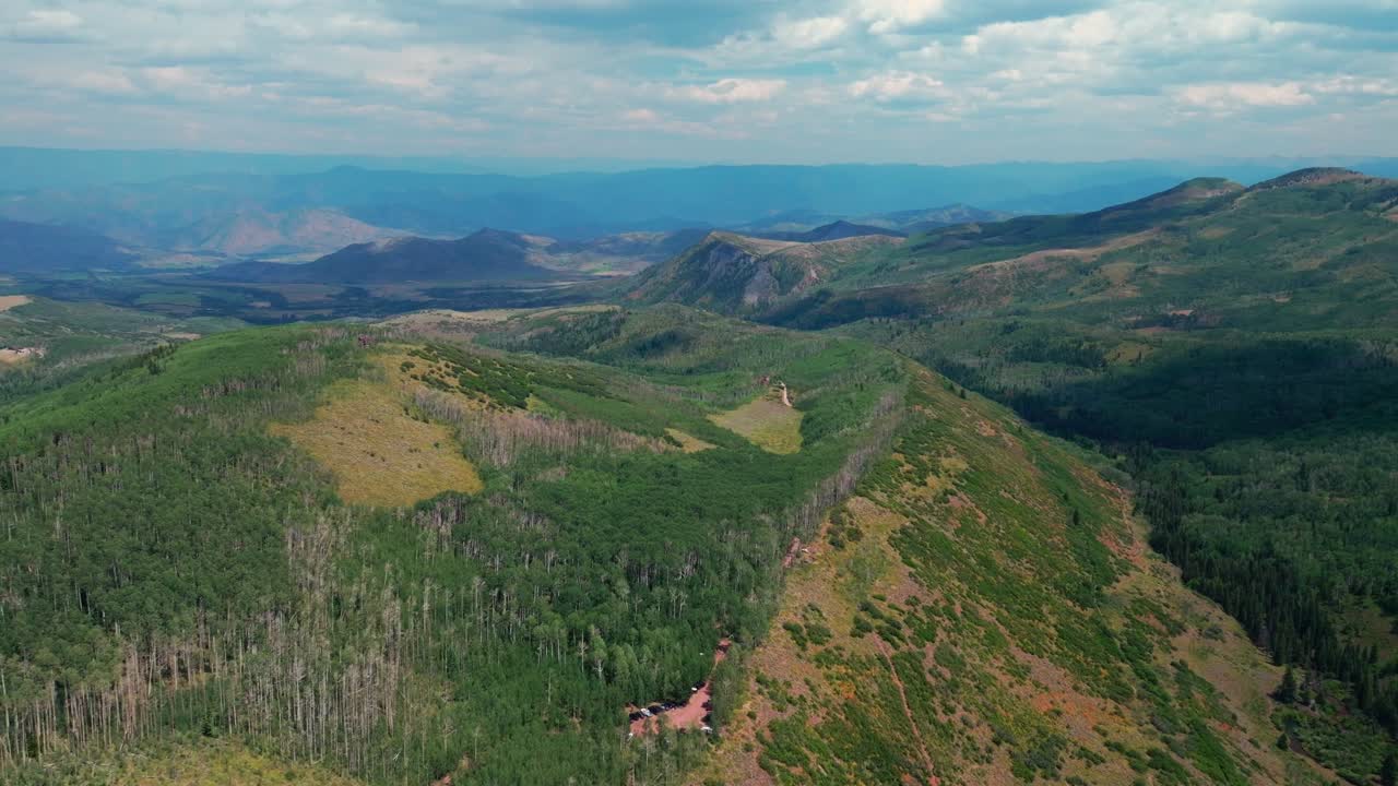 Capitol peak creek ditch trailhead parking lot spring summer 14er aerial drone Colorado Aspen Old Snowmass Elk Rocky Mountains Range Aspen grove White River Forest sunny blue sky forward down