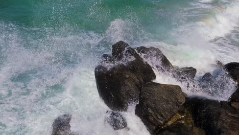 splashing waves on the rugged shore of malpica beach in spain