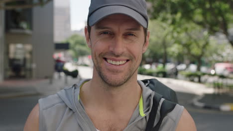 portrait of attractive fit young man wearing sportswear smiling happy cheerful enjoying city lifestyle