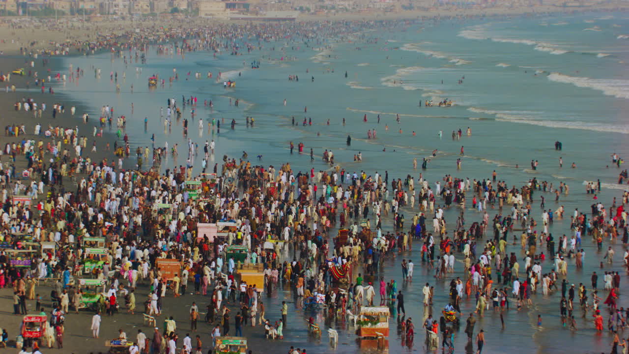 Aerial view over the sea view beach at Karachi Pakistan, Hundreds of people are together to enjoy beautiful blue sea