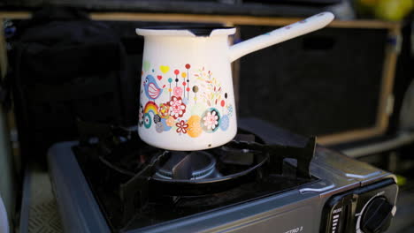 blue flame gas cooker burner, with a coffee pot preparing the morning coffee