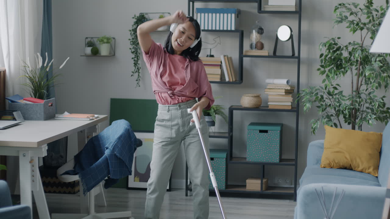 Woman cleaning her home while listening to music