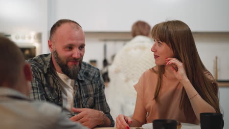 Man-woman-and-child-communicate-sitting-at-kitchen-table