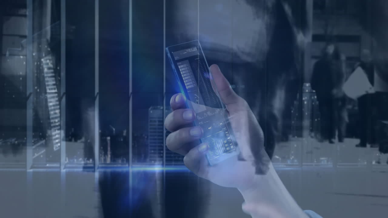 Holding smartphone, hand displaying digital animation over cityscape at night