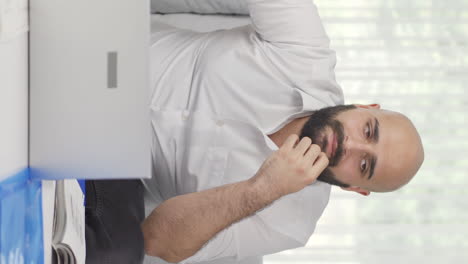 vertical video of home office worker man thoughtful.