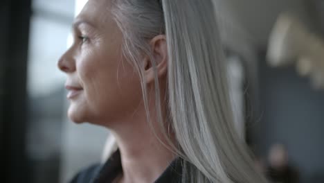 senior business woman looking outside window