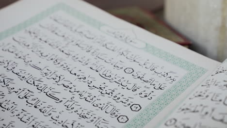 Macro shot of Arabic book in mosque slowing moving back, slow motion