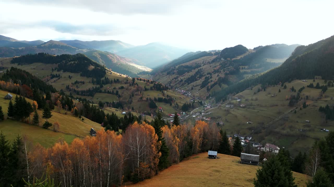 Highlands Overlooking Moieciu de Sus Village Near Amfiteatrul Transilvania In Romania. Aerial Drone Shot