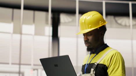 vertical video engineer inspecting solar panel production lines using laptop