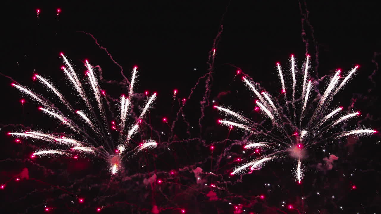 Festive fireworks lighting the night sky with energetic colorful bursts