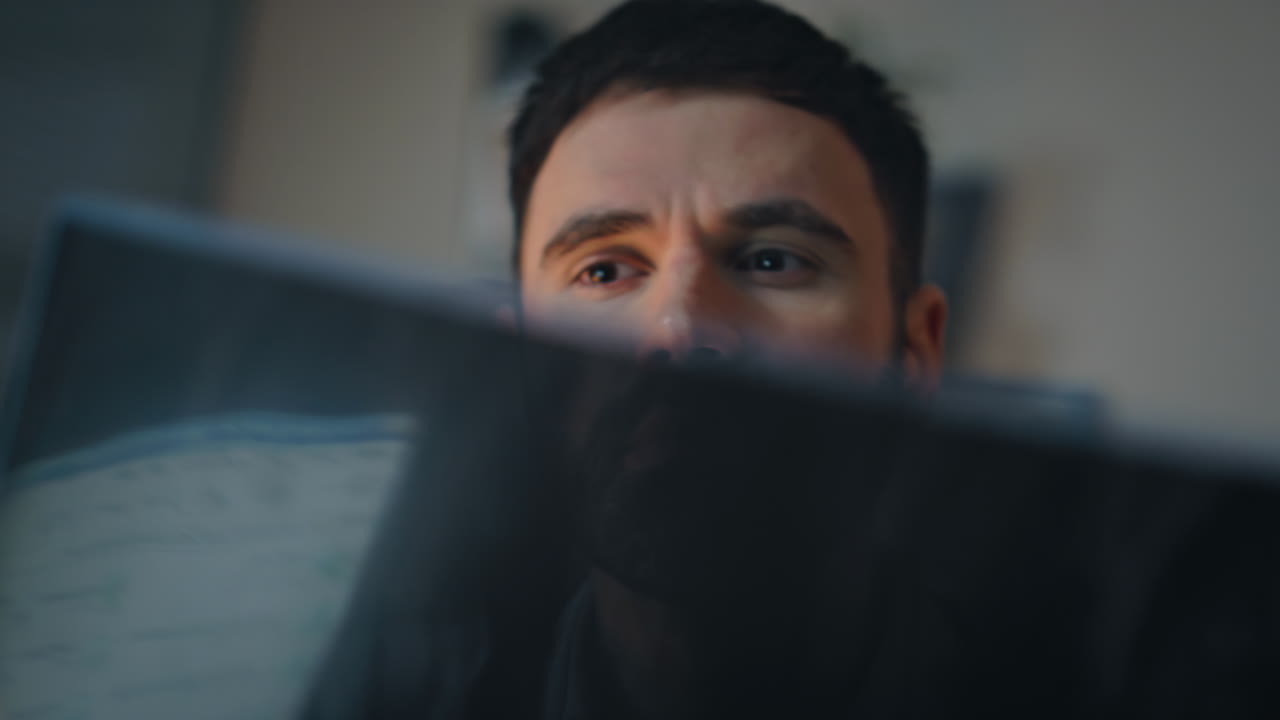 Doctor looking patient radiology scan closeup. Eyes peeping behind medical image