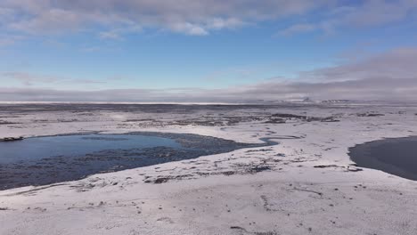 panoramic snowy icelandic mountains reflect in still fjord near borgarnes under blue sky