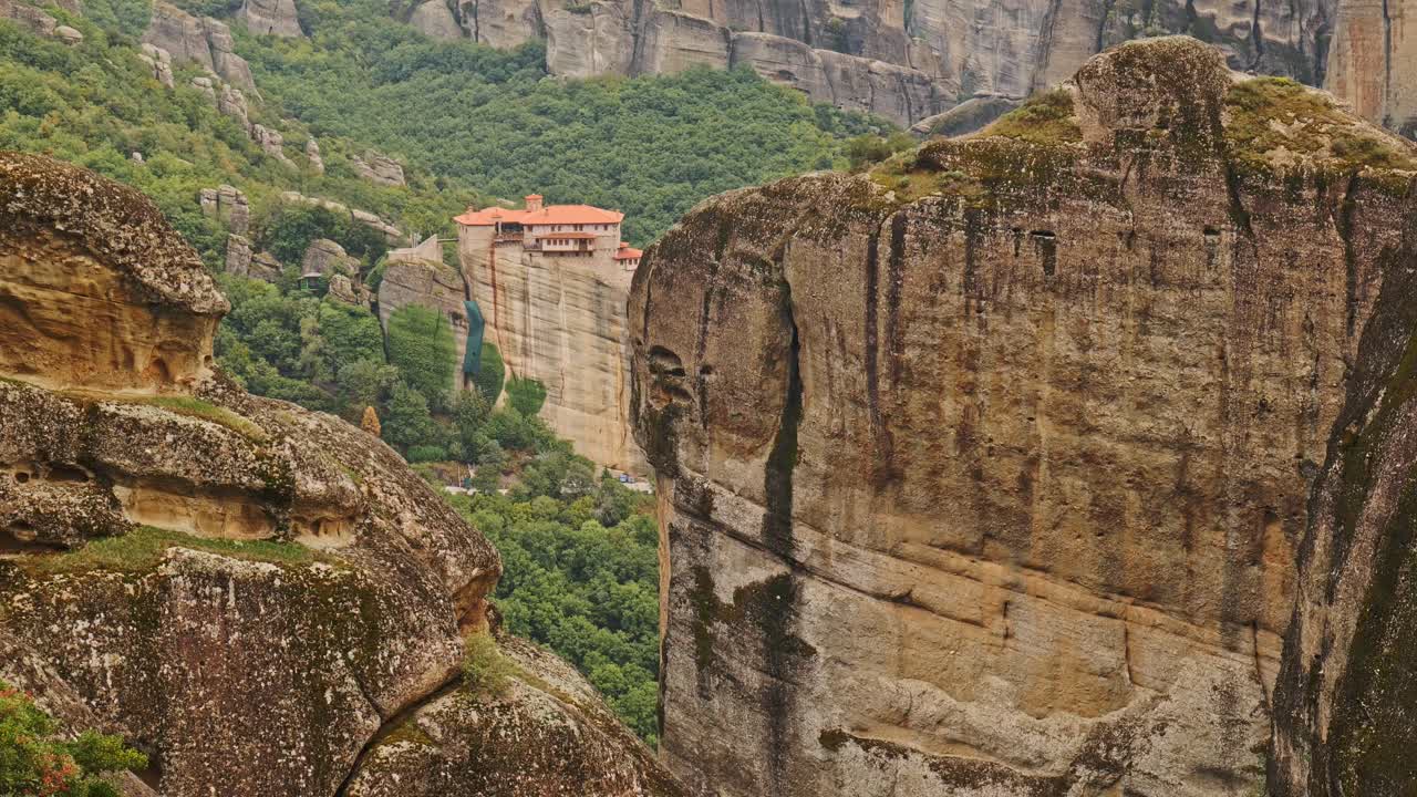 St Nicholas Greek monastery amid vertical rock formation landscape