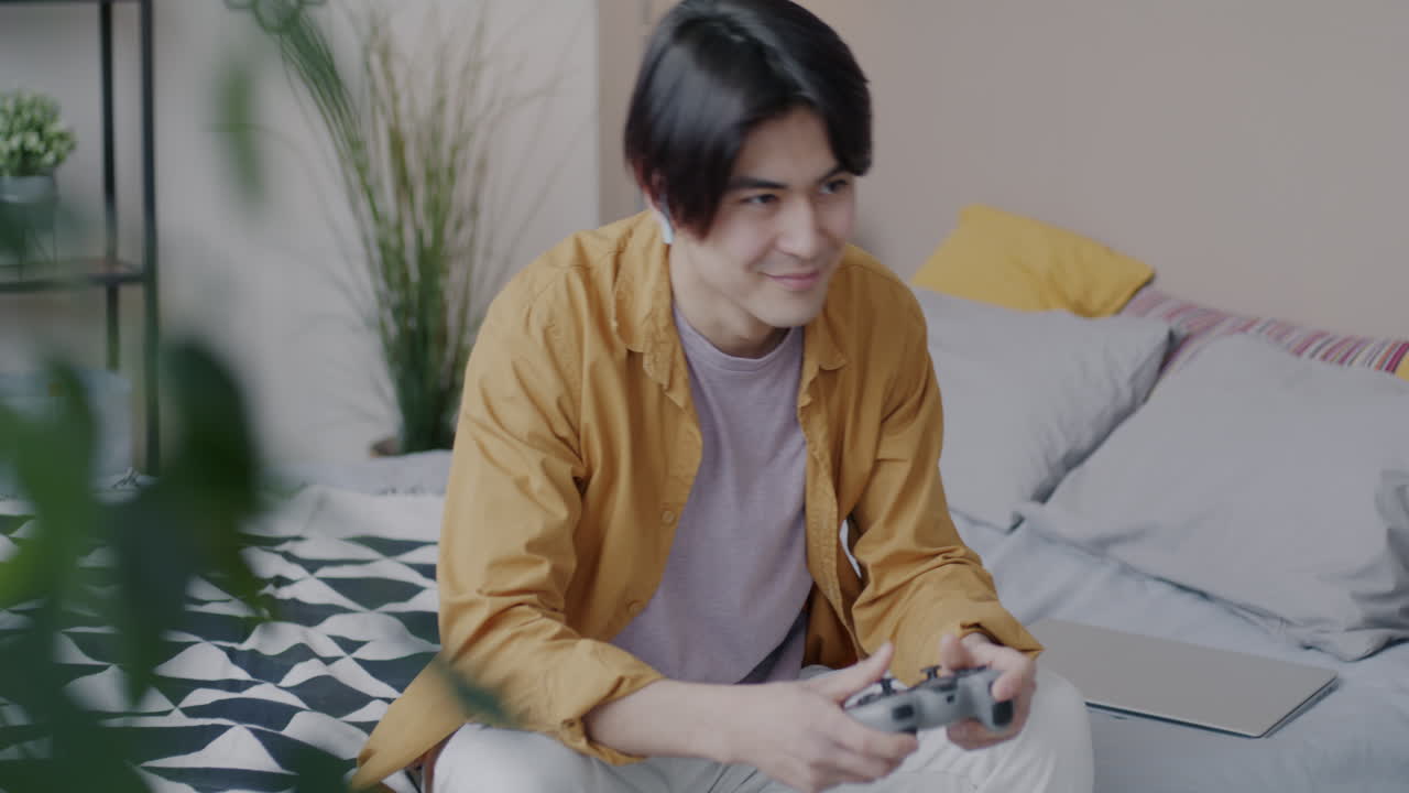 Young Man Gaming in His Bedroom