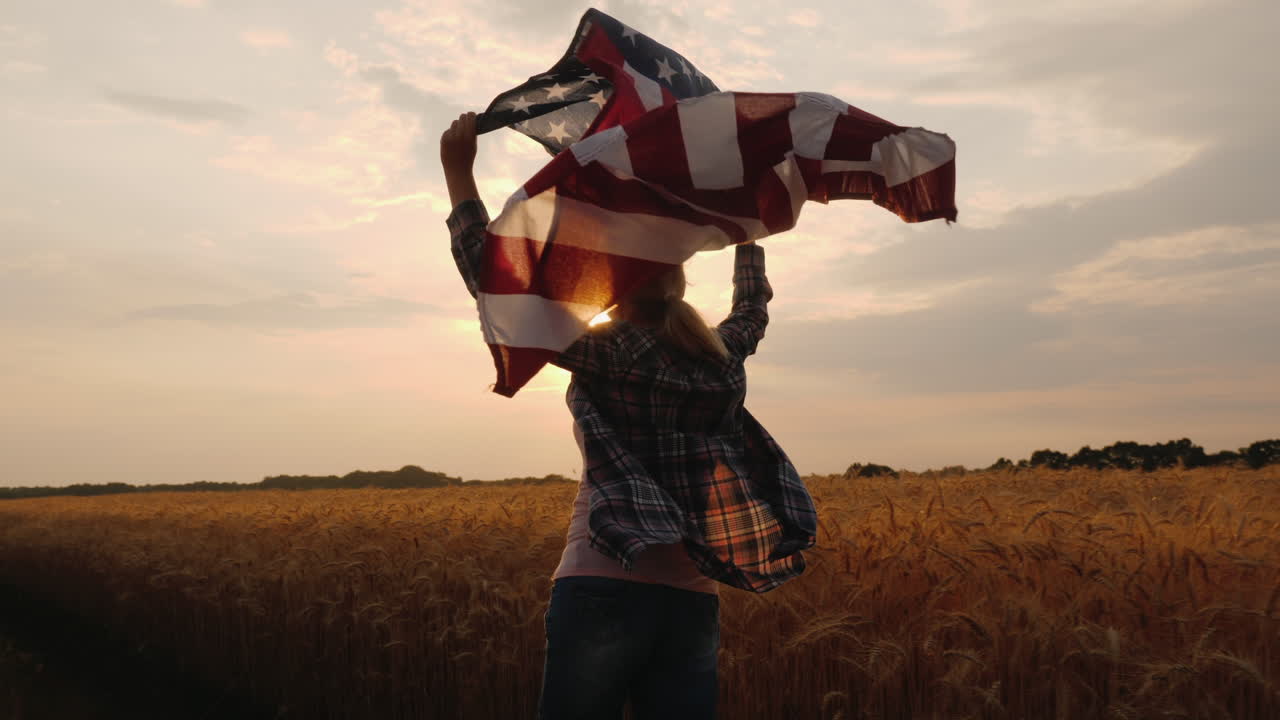 Woman With Usa Flag Runs In The Sun On A Wheat Field