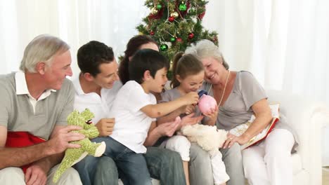 panorama of family playing with christmas gifts in the livingroom