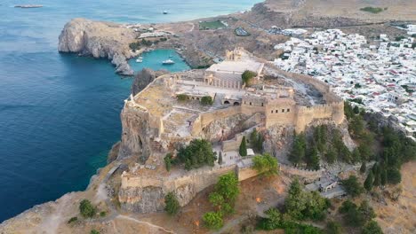 Cinematic-Aerial-drone-shot-above-ruins-of-Acropolis-of-Lindos,-Rhodes,-Dodecanese-Islands,-Greek-Islands,-Greece,-Europe