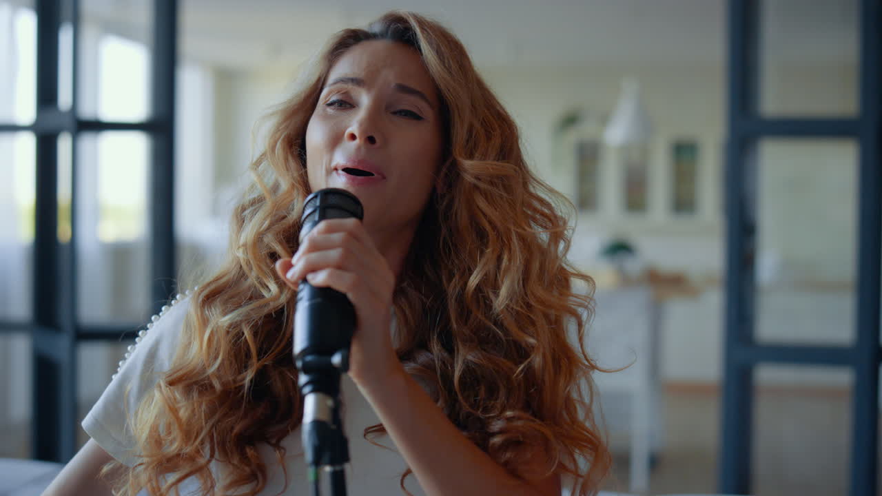 Woman performing musical song in microphone. Cheerful singer practicing vocal