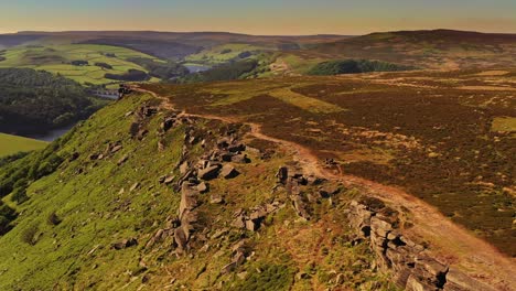 Aerial-shot-with-dynamic-movement-tracking-people-walking-on-a-mountain-ridge