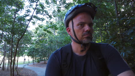 man riding a bike on a footpath close up