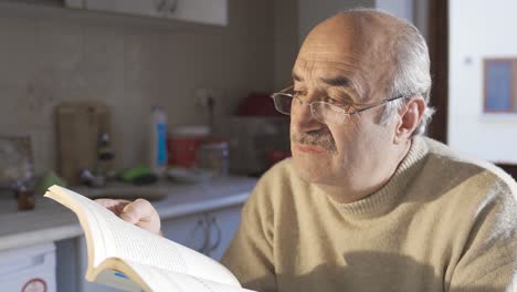 cultured old retired man studying, learning and learning at home.