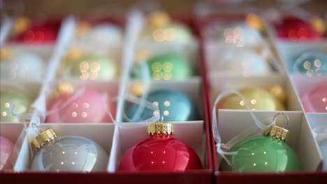 foreground view of reflective, colorful christmas balls neatly packed in a box