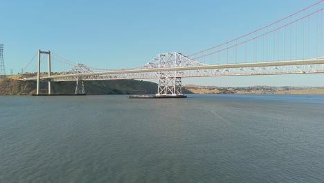 panning drone perspective highlights the scale and symmetry of the alfred zampa bridge spanning the northern california waterway