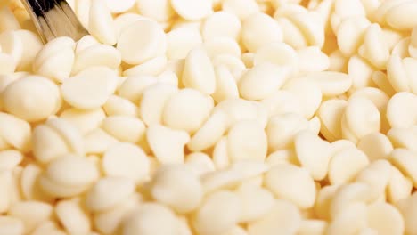 close-up view of white chocolate chips being stirred