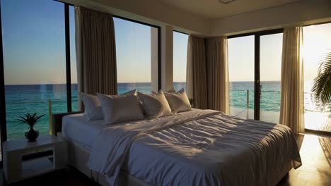 luxury oceanfront bedroom at sunset