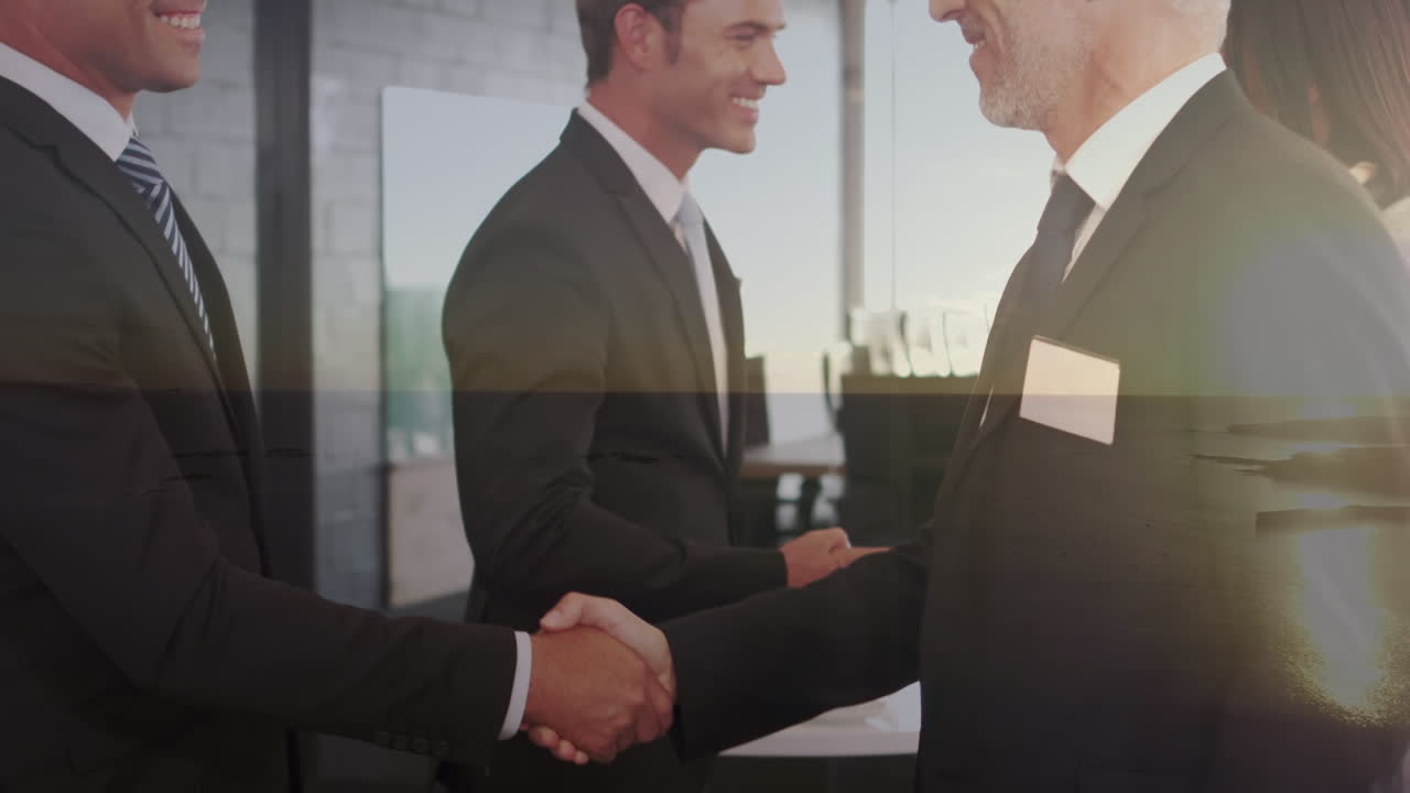 Animation of happy caucasian businessmen shaking hands over seascape