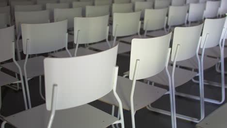 lines of empty white chairs