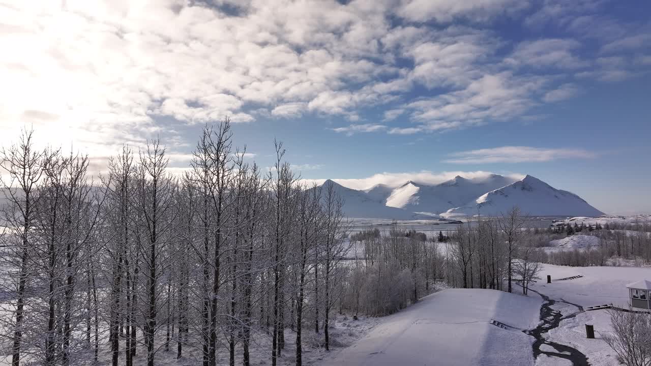 Snowy peaks of Hafnarfjall and surrounding ranges rise above Borgarfjörður bay in Iceland