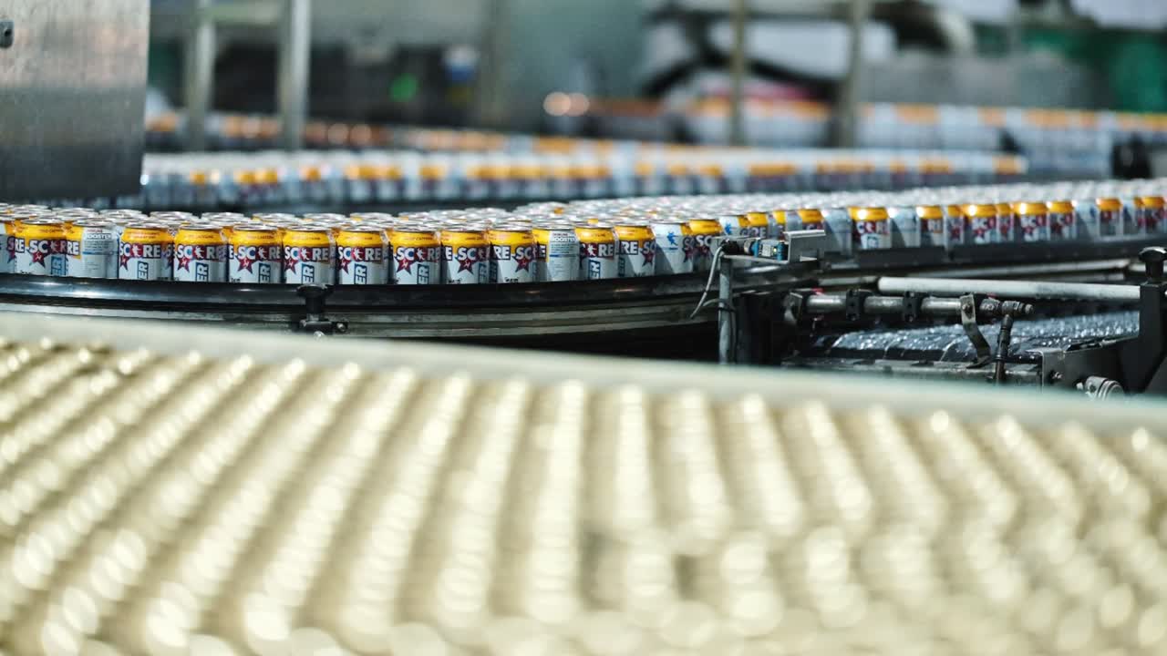Thousands of cans of beverages moving through a factory