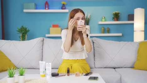 young woman plucking her eyebrows with tweezers. facial care.