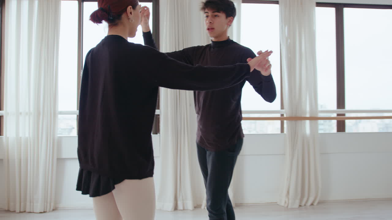 Pair of Young Ballet Dancers Having Rehearsal in a Studio