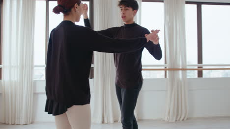 pair of young ballet dancers having rehearsal in a studio