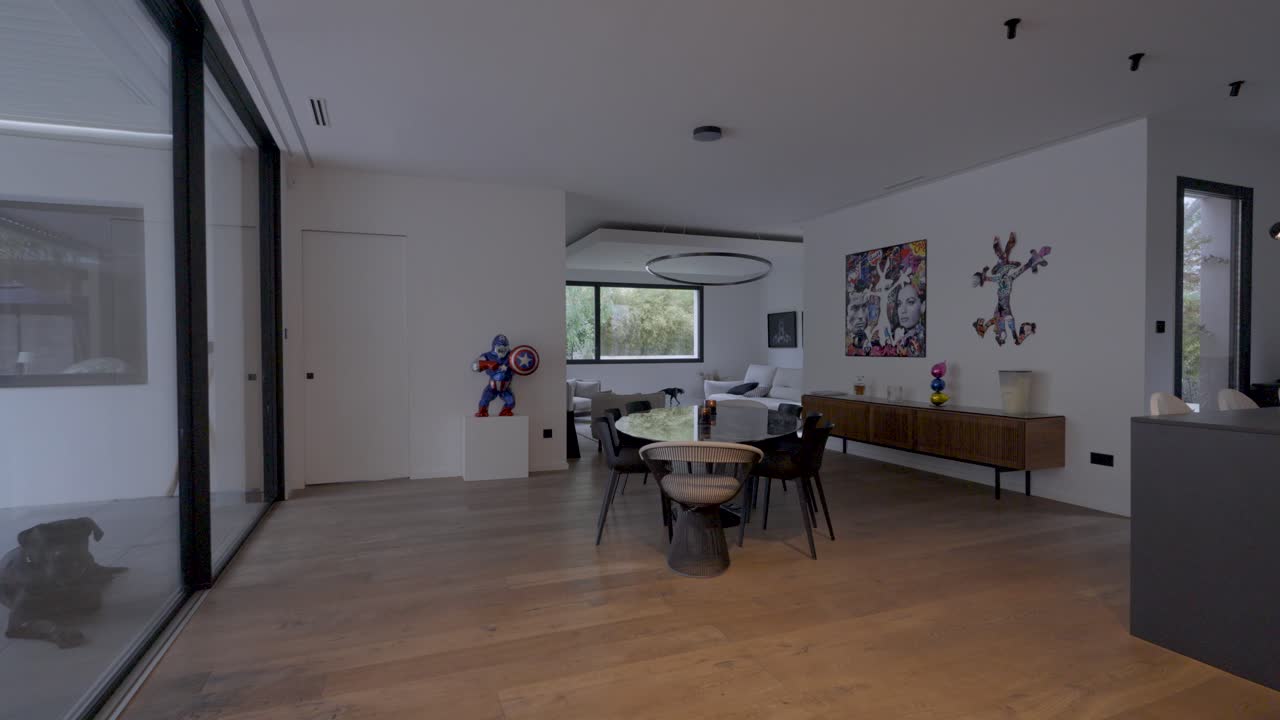 Slow establishing shot of lights turning on throughout a hallway and living room