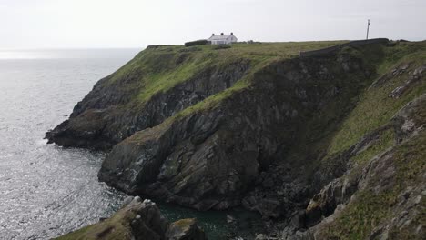 bailey cottage on top of coastal cliff in howth, dublin, ireland